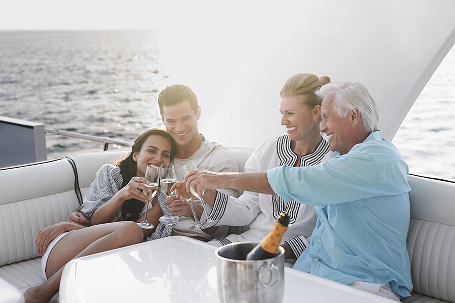 Personal Insurance - Couple and Parents Toasting With Champagne on a Yacht